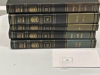 Stack of five hardcover volumes from the Great Books series, showing spines with gold detailing.