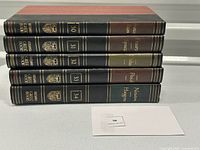 Stack of five volumes of Britannica Great Books of the Western World, volumes 30 to 34 showing leather-look spines with gold gilt detailing and authors' names.