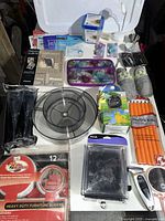 Overview of all miscellaneous items including storage containers, furniture sliders, cosmetic bag, and personal care sachets.