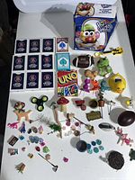 Overview of lot including Mr. Potato Head in box, playing cards, figurines and assorted toys.