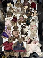 Full lot of 21 vintage Boyd's Bears collectible plush bears on white surface