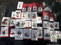 Full overview of large lot showing arranged boxed Disney Hallmark Keepsake ornaments in various designs and characters