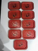 Top view of all nine trays arranged in three rows, showing red color and peacock print.