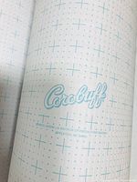 Top view showing Corobuff brand logo and grid pattern on the paper roll surface.