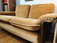 Front three-quarter view of sofa showing upholstery color, cushion shape, armrest and overall design