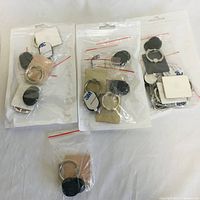 Image shows seven phone ring stands in sealed plastic packaging, each with metal ring and adhesive square base.