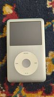Front view of Apple iPod Video showing screen and click wheel, screen appears off