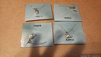 Four unopened Effy necklaces with heart-shaped pendants displayed on blue branded cards
