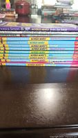 Stack of 11 Horrid Henry children's books by Francesca Simon, showing spines with titles and author names