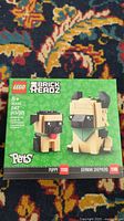 Front view of unopened Lego 40440 BrickHeadz German Shepherd and Puppy set showing box art and piece count of 247 pcs.