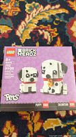 Front view of unopened Lego 40479 BrickHeadz Dalmatian set box showing the two dog figures and branding.