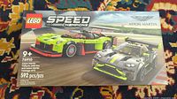 Front of sealed Lego 76910 box showing both Aston Martin car models on racetrack with Lego and Aston Martin branding