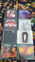 Front of the eight Metallica CD covers arranged in two columns with album titles visible.