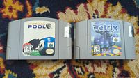 Photo showing two Nintendo 64 game cartridges: Virtual Pool and Wetrix, on a patterned surface.