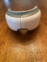 Image of the eye massager's smooth white and gray exterior.