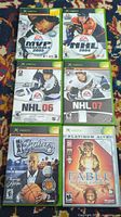 Six original Xbox game cases laid out showing front cover artwork of sports games and Fable