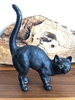 Full side view of vintage black cat door stop showing detailed body and upright tail.