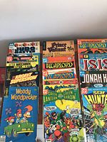 Photo showing full view of 14 comics including Judge Dredd, Prince Valiant, Warlord, Mighty Isis, Jonah Hex, Woody Woodpecker, Green Lantern, Green Arrow, and Star Hunters.