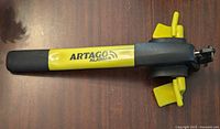 Top view of the Artago 870 steering wheel lock, showcasing the yellow and black design and alarm branding.