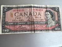 Front side of a 1954 Canadian two-dollar banknote showing serial number, portrait of Queen Elizabeth II, and bilingual denomination text.