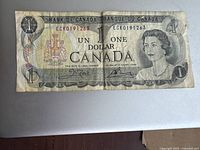 Full front view of the 1970s Canadian one dollar bill showing Queen Elizabeth II portrait, serial number, and text in English and French.