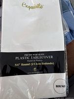 Photo of the unopened plastic table cover packaging showing brand, size, shape, and material details.