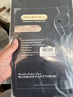 Front packaging view of Honeysea women's pantyhose in nude color showing brand, material composition (Polyamide 87%, Spandex 13%), and product features.
