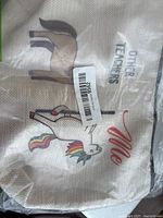 Photo of a small beige canvas tote bag with cartoon prints of a horse and unicorn, labeled to contrast 'OTHER TEACHERS' and 'Me'.