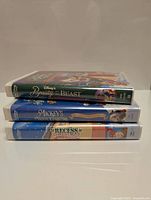 Stack of four Disney Christmas-themed VHS tapes showing spines with titles and Disney branding