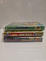 Three Disney VHS tapes stacked horizontally showing front case spines, titles clearly visible in French.
