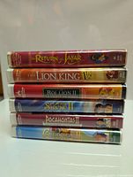 Stack of six Disney sequel VHS tapes showing spines with titles and artwork.
