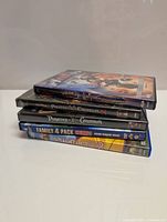 Stack of 5 DVD cases clearly showing titles including Pirates of the Caribbean, Family 4 Pack, Stuart Little 2, Spy Kids 3D Game Over