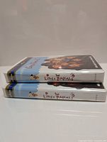 Two sealed VHS copies of The Little Rascals stacked on their side showing spines and cover art