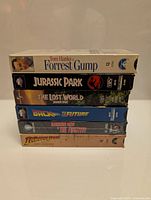 Stack of six classic movie VHS tapes in their cardboard slipcovers, vertically stacked showing titles clearly