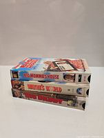 Photo of three comedy movie VHS tapes stacked horizontally showing spines: Big Momma's House, Wayne's World, Big Daddy