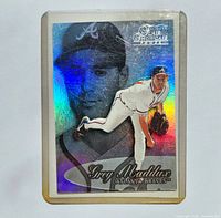 Front of the 1999 Flair Showcase #31 Greg Maddux baseball card with holographic detail and images of Greg Maddux pitching and a portrait.