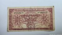 Front of Belgium 5 Francs 1943 banknote showing serial number and ornate design in brown/red ink.