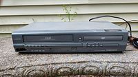 Front view showing VHS player side with 4 HEAD label and multiple control buttons