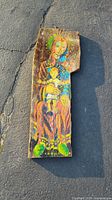 Photo of one reclaimed milled wood panel with colorful painting of the Blessed Mother holding child, showing wood texture and artwork detail