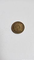 Top side of coin displaying crescent star emblem and Turkish inscription with date 1955