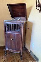 Full view of upright phonograph cabinet with lid closed