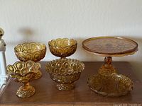 Full set showing 6 amber glass Moon & Stars pieces: cake stand, compotes, candy dishes