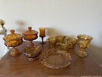Full set on wooden surface showing all amber brown glass pieces with Moon and Stars pattern