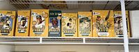 Seven Oakland A's bobbleheads in yellow original boxes lined up in a row.