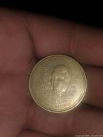 Obverse side of the Mexican $1000 Peso coin showing denomination, year, and female figure.