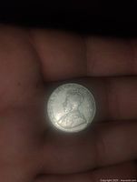 Obverse side of the 1920s Canadian nickel showing crowned King George V portrait and inscriptions.