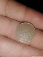 Close-up photo of a 1936 Canadian one cent coin showing the denomination and maple leaf design on the face.