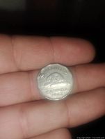 Reverse side of a 1944 Canadian nickel showing a beaver on a log with date and 'Canada' text.