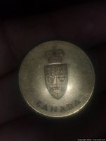 Obverse side showing Canadian Coat of Arms with crown and 'CANADA' text below.