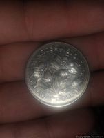 Front side of the coin showing floral design for Manitoba and the text 'MANITOBA 1870 CANADA DOLLAR 1970'.